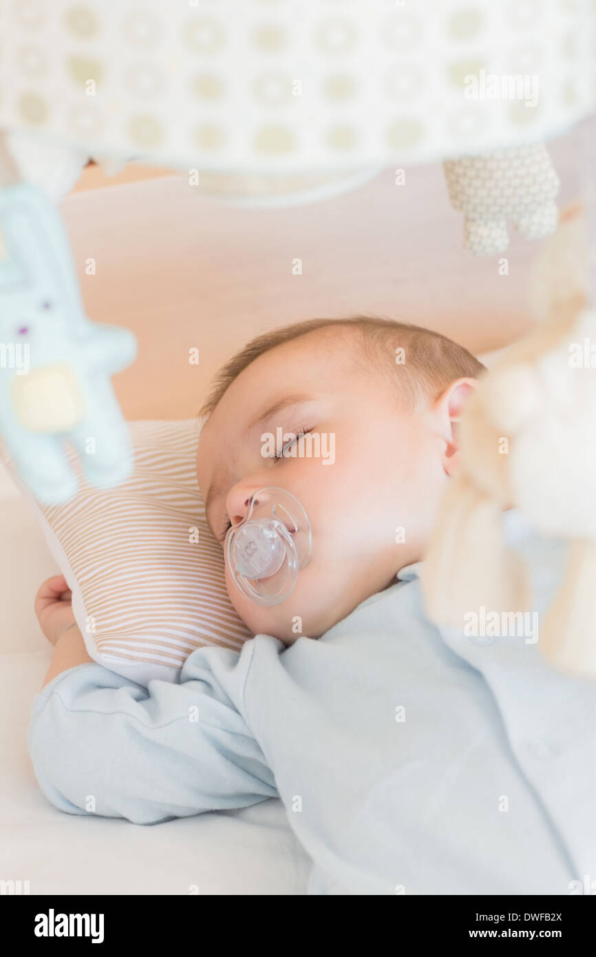 Baby boy sleeping in crib Stock Photo Alamy