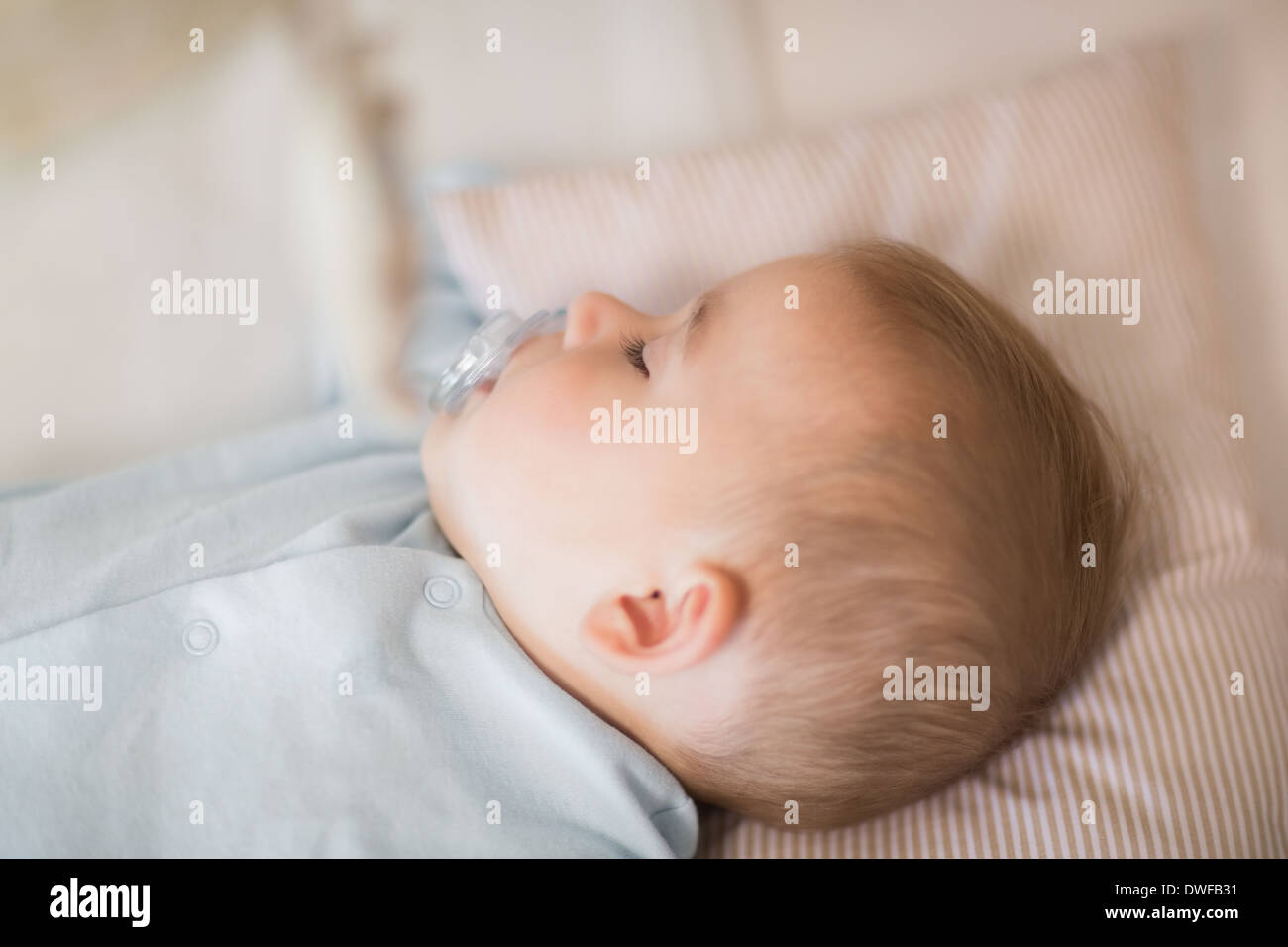 Baby boy sleeping in crib Stock Photo Alamy