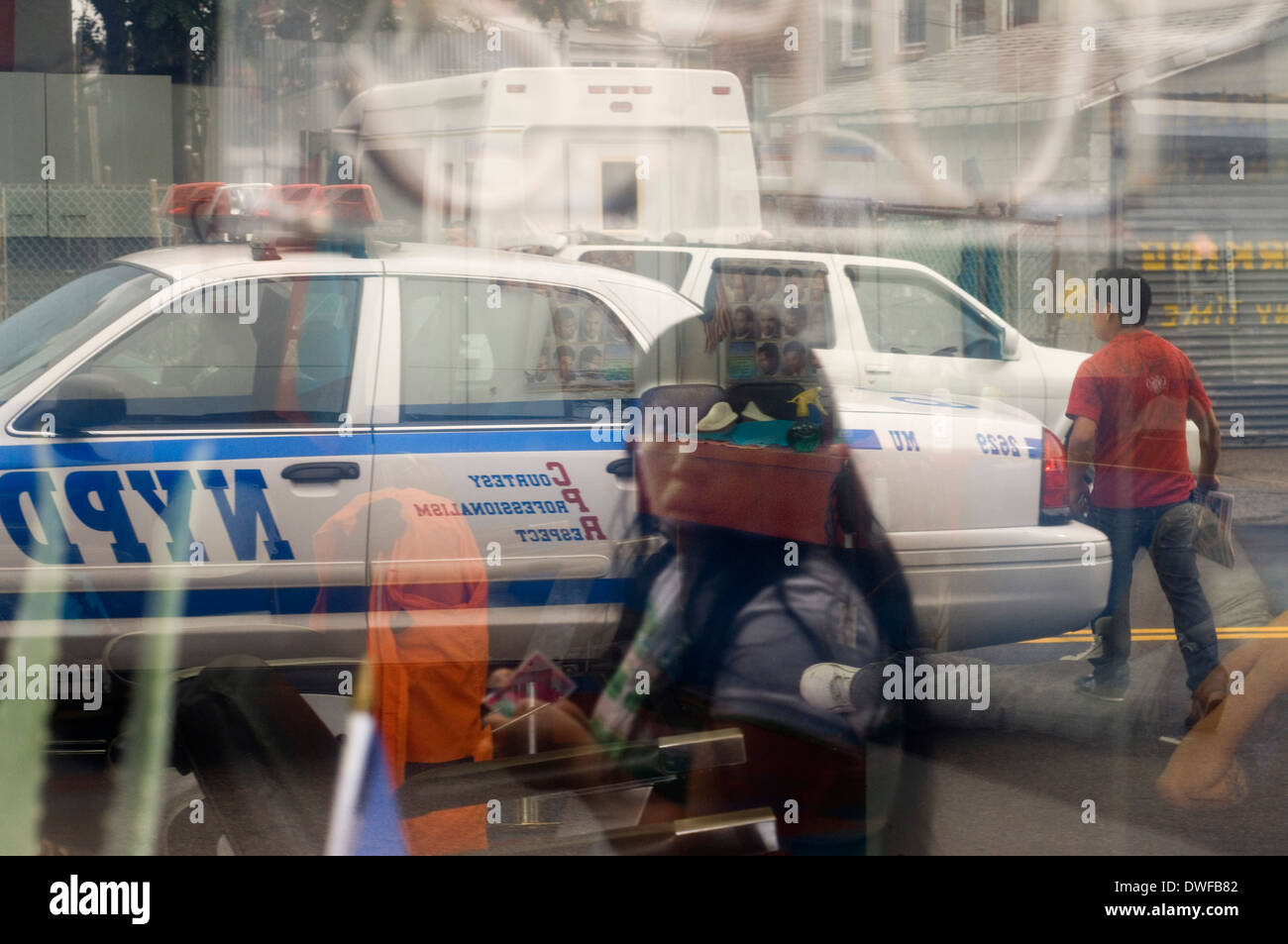 Reflection of a police car in Queens showcase . Queens is the largest neighborhood in New York , is a county also has to his ter Stock Photo