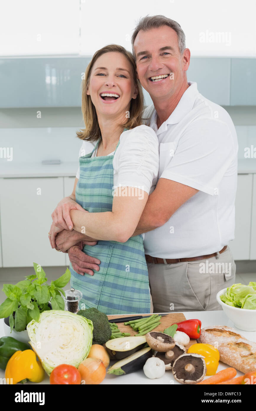 Side view of a man embracing woman in kitchen Stock Photo - Alamy