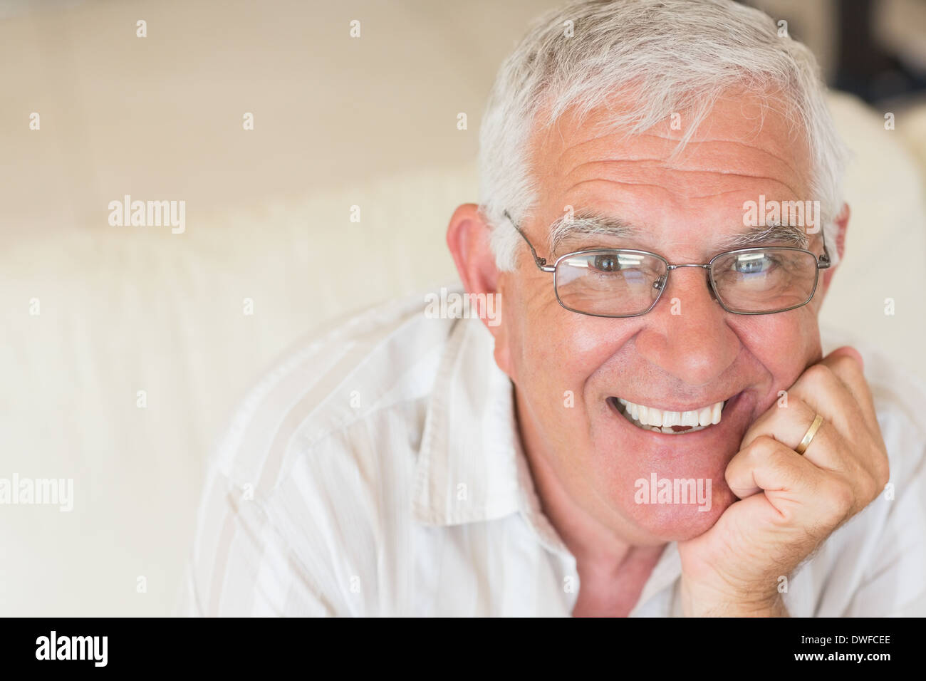 Smiling man sitting on couch hi-res stock photography and images - Alamy
