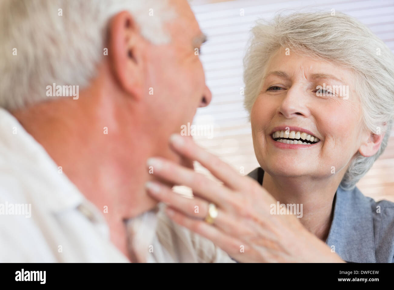 Smiling senior couple sitting on the couch Stock Photo