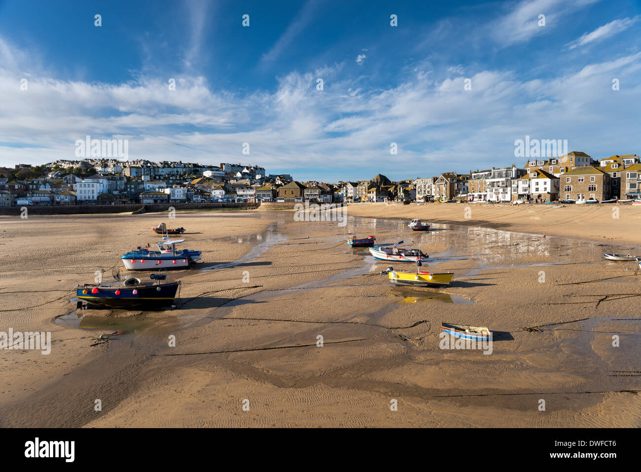 Fishing boats on the beach and the seafront at St Ives in Cornwall Stock Photo