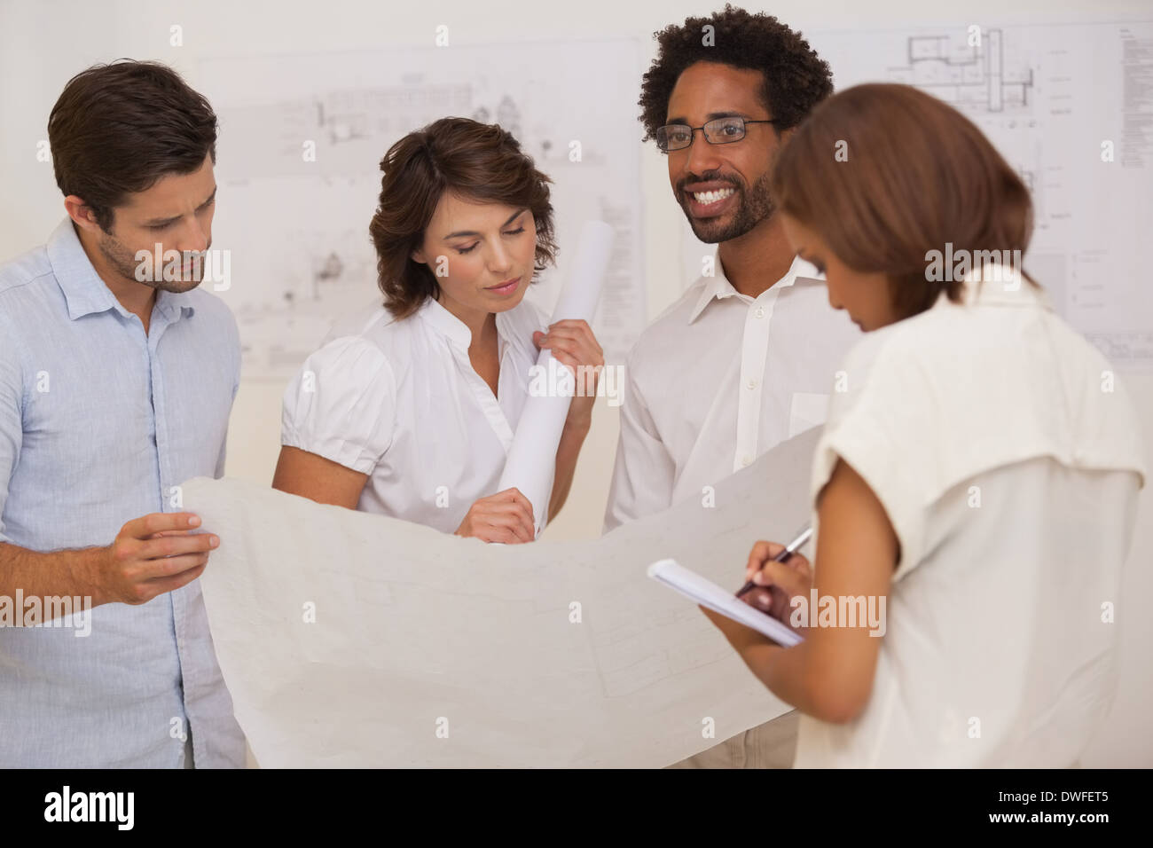 Group of architects working on blueprints Stock Photo