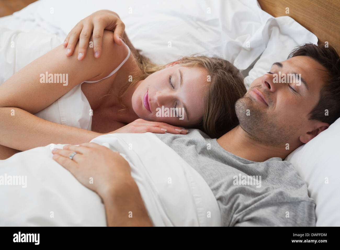 Young couple sleeping together in bed Stock Photo