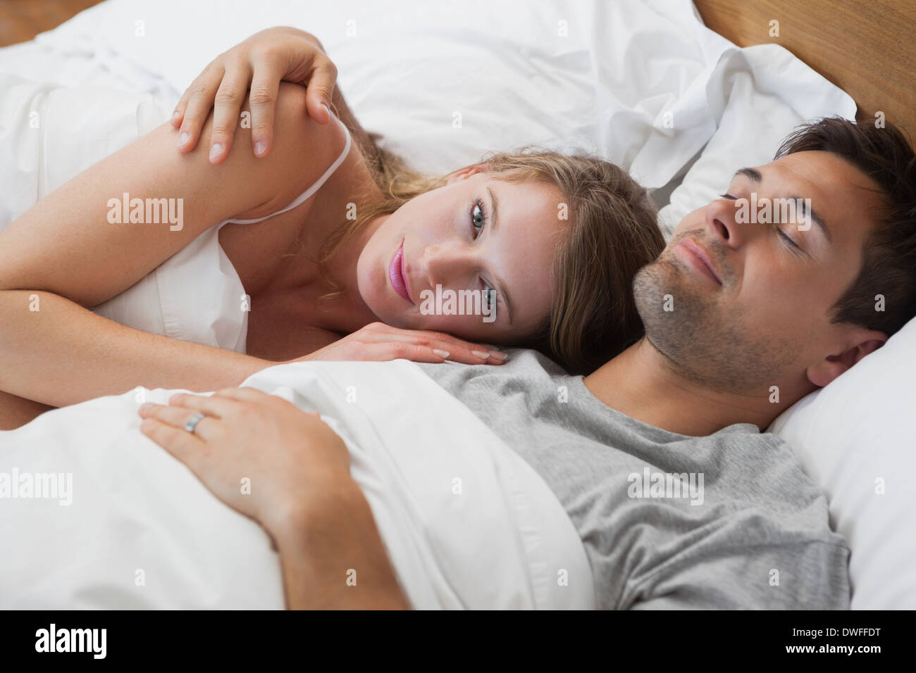 Young couple sleeping together in bed Stock Photo