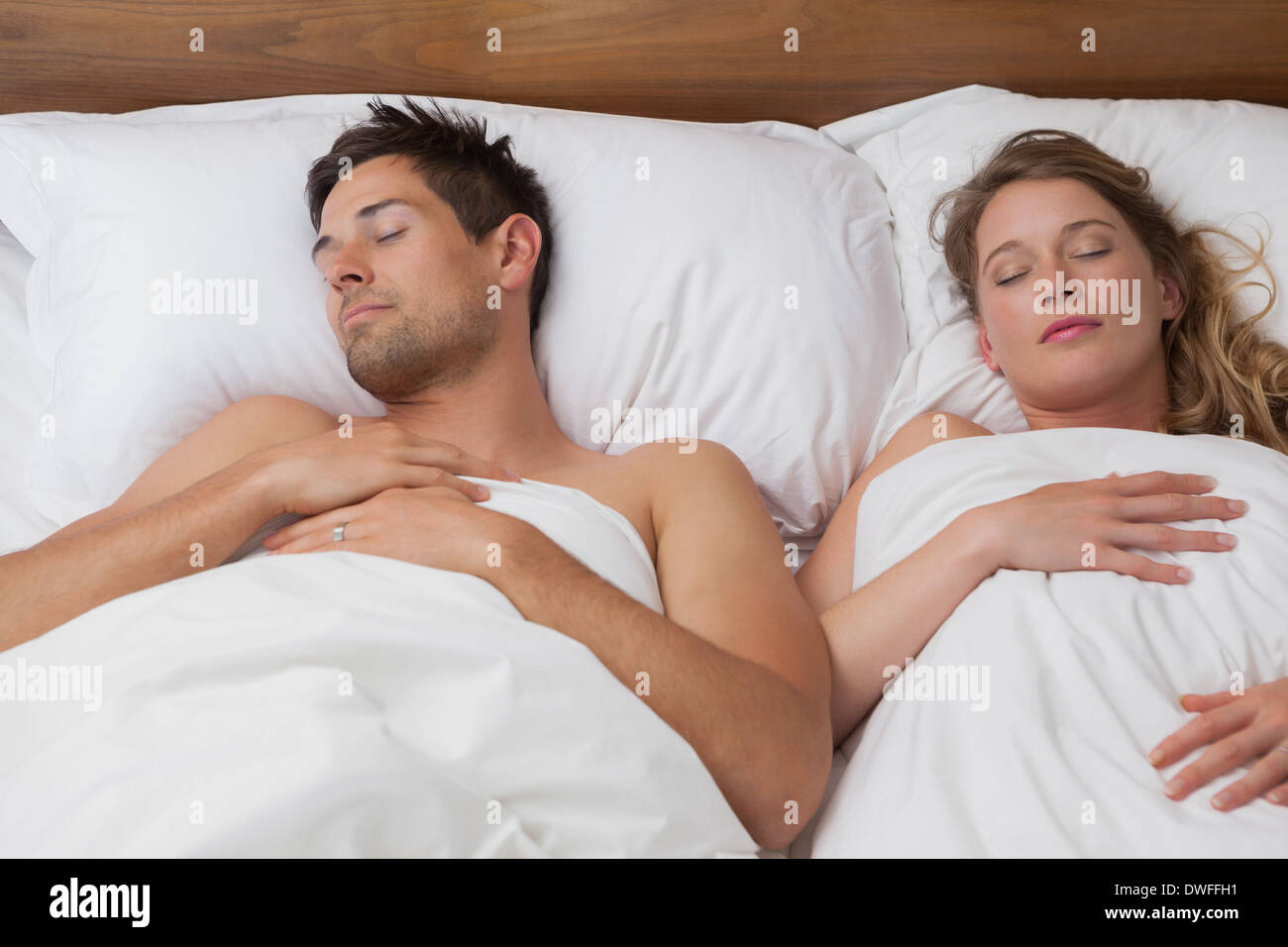 Young couple sleeping in bed Stock Photo