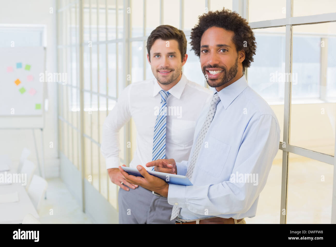 Two businessmen with digital tablet in office Stock Photo