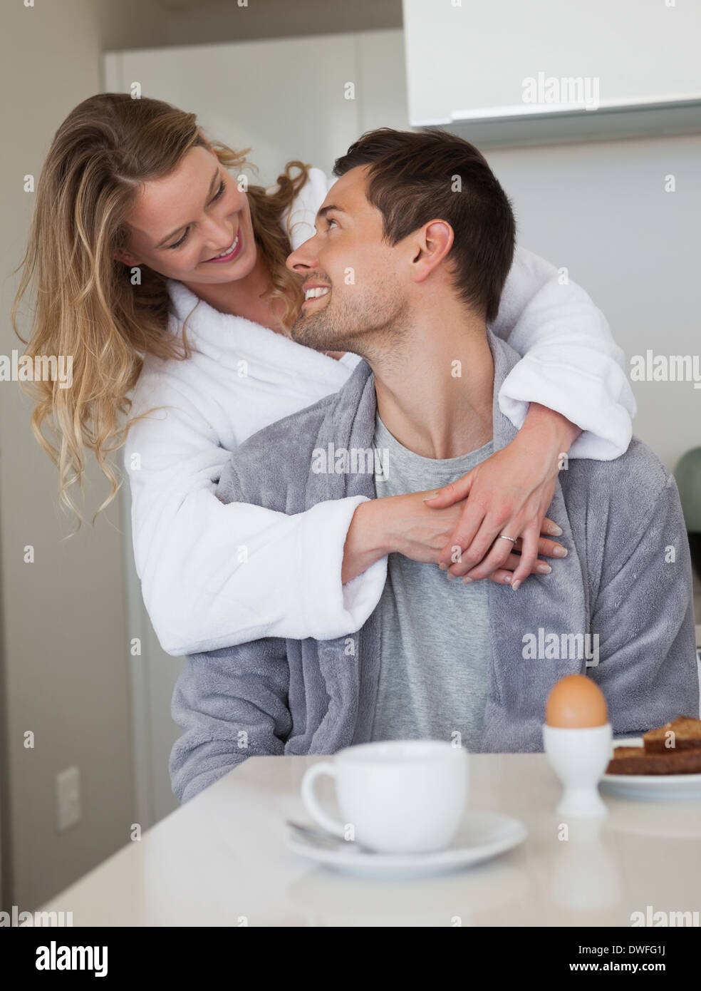 Loving couple looking at each other in kitchen Stock Photo