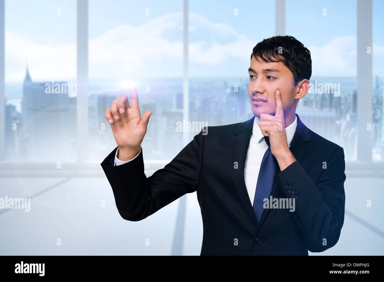 Serious businessman touching light Stock Photo