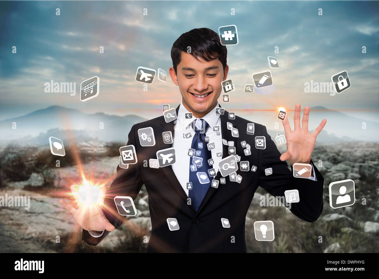 Smiling businessman touching apps Stock Photo