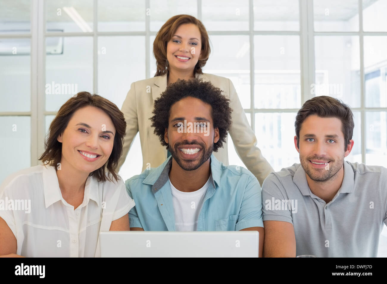 Portrait of smiling business people using laptop Stock Photo - Alamy