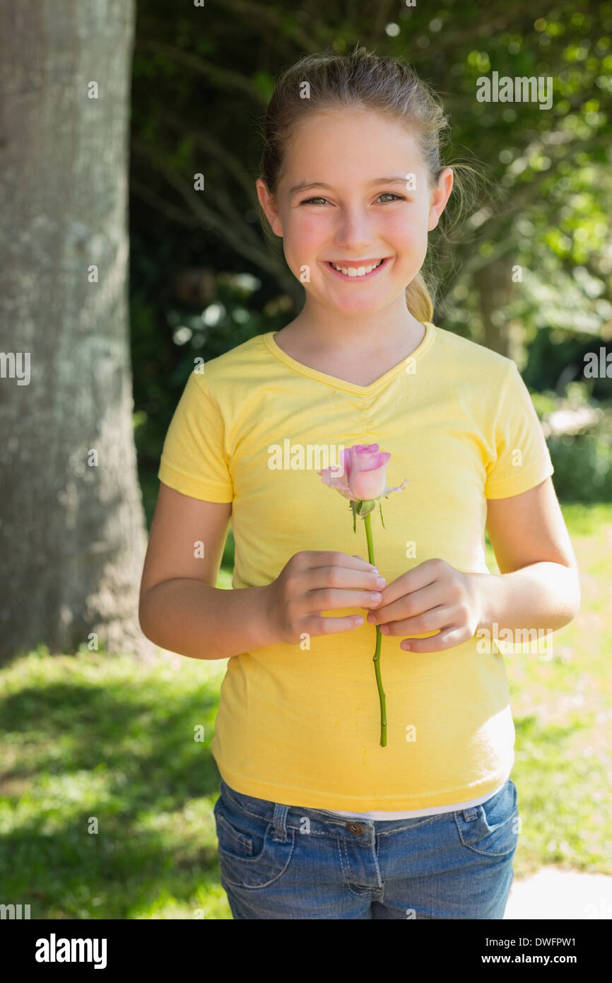 Girl holding flower in park Stock Photo