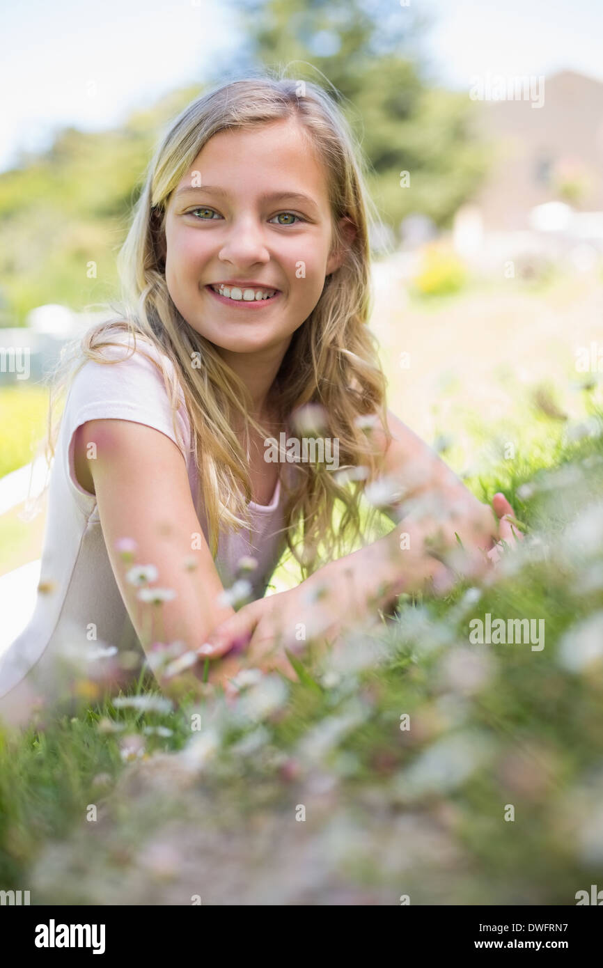 Happy girl lying on grass in park Stock Photo - Alamy