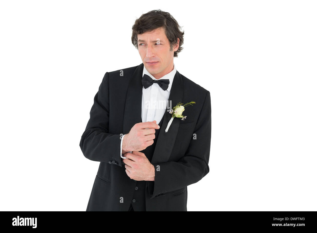 Groom in tuxedo adjusting cuff link Stock Photo