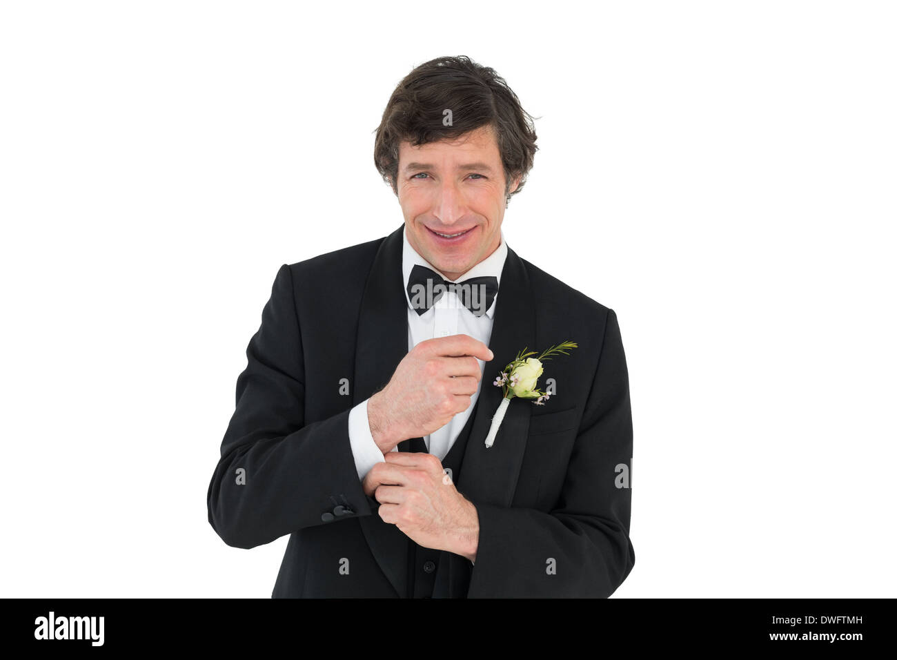 Smiling groom in tuxedo getting ready Stock Photo