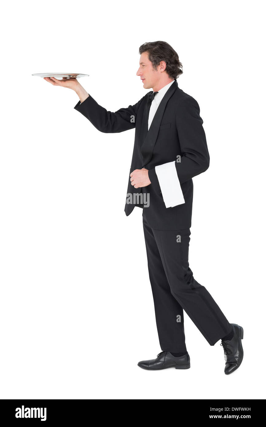 Waiter in suit carrying tray over white background Stock Photo Alamy