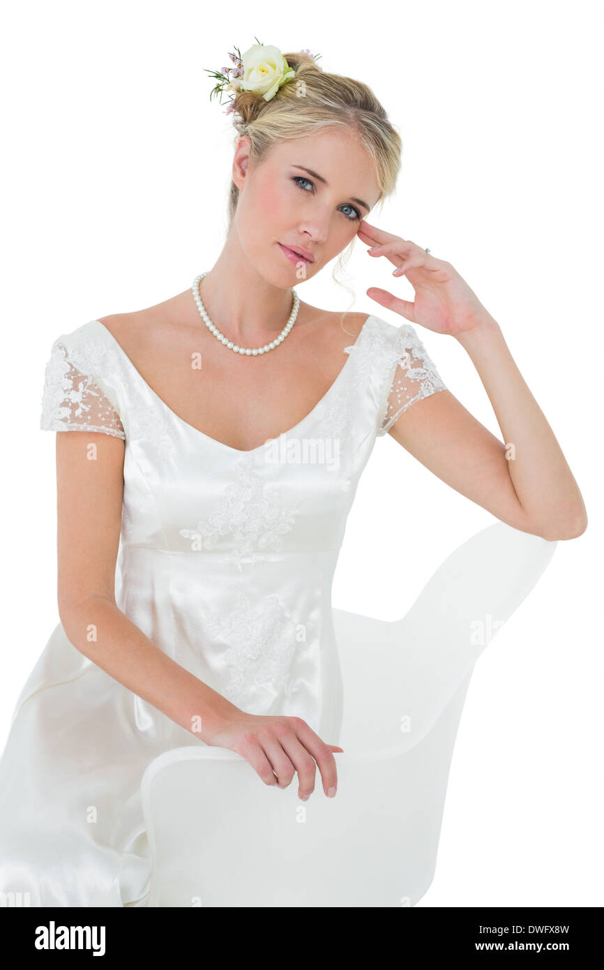 Beautiful bride sitting on chair over white background Stock Photo - Alamy