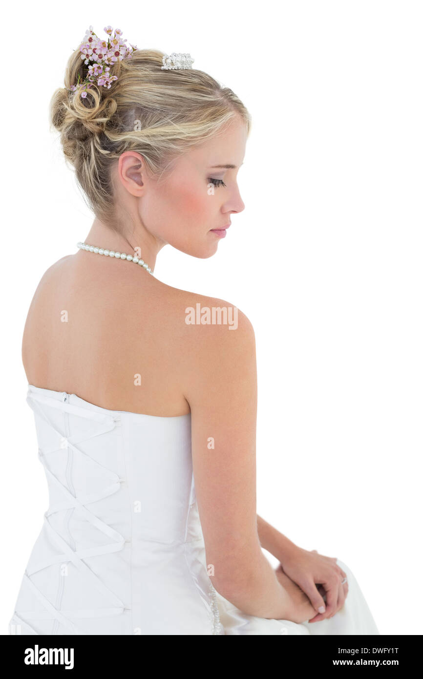 Bride in off shoulder dress against white background Stock Photo