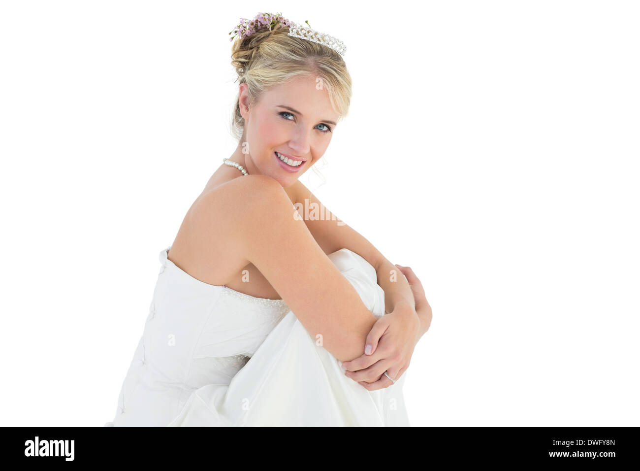 Young bride hugging knees over white background Stock Photo