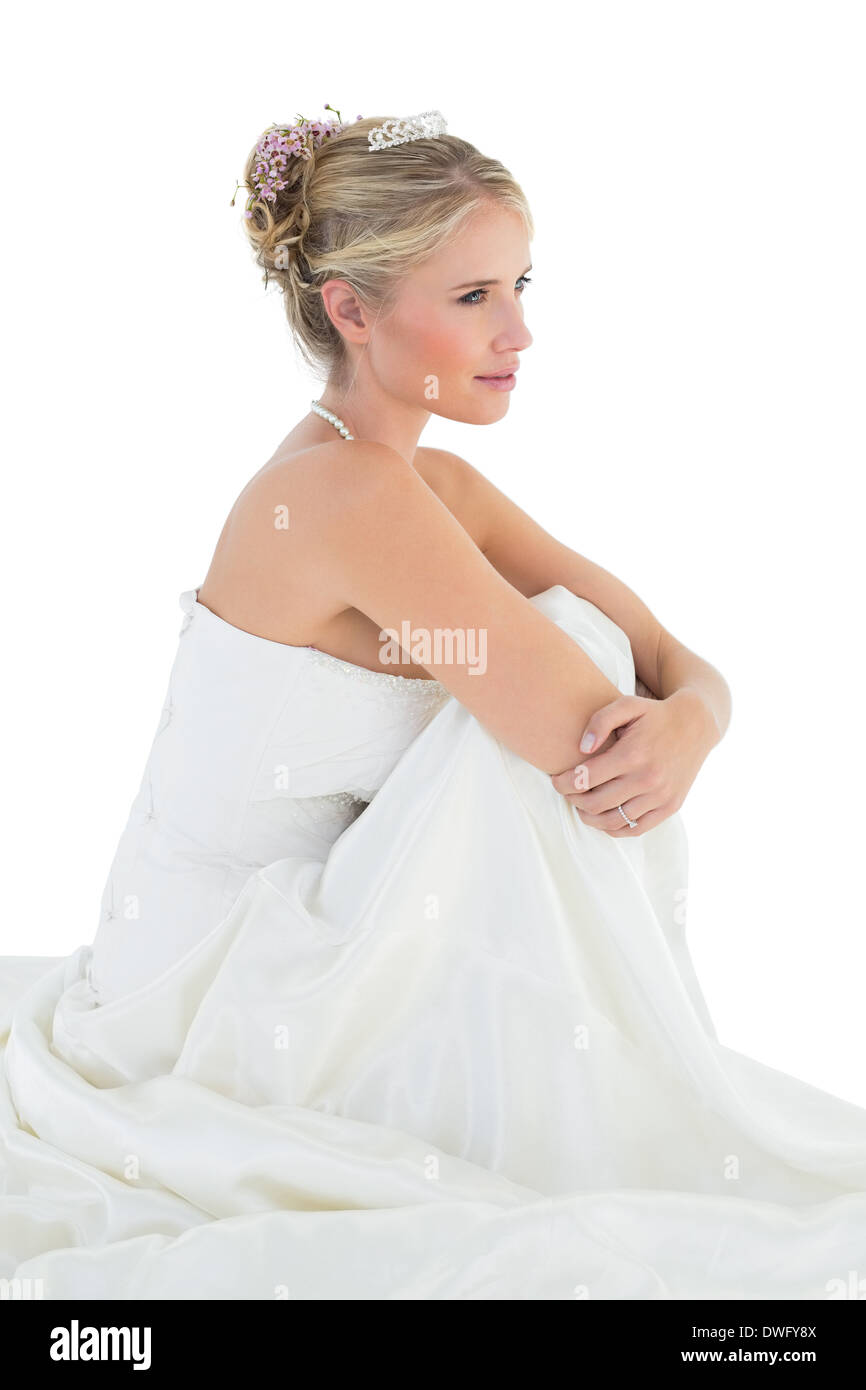 Bride hugging knees over white background Stock Photo