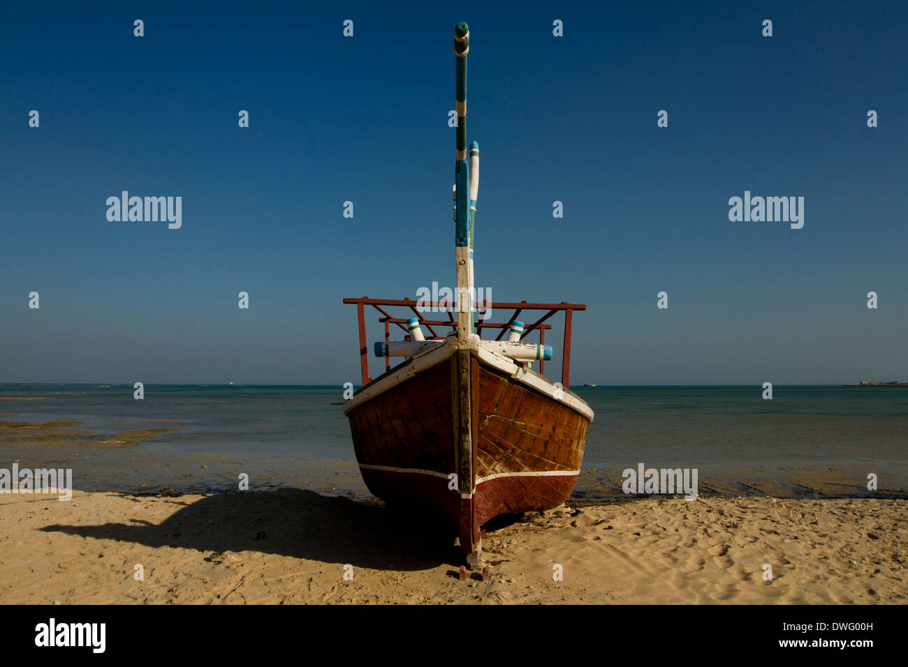 Beached traditional dhow boat and beach in Al Wakra, Qatar Stock Photo