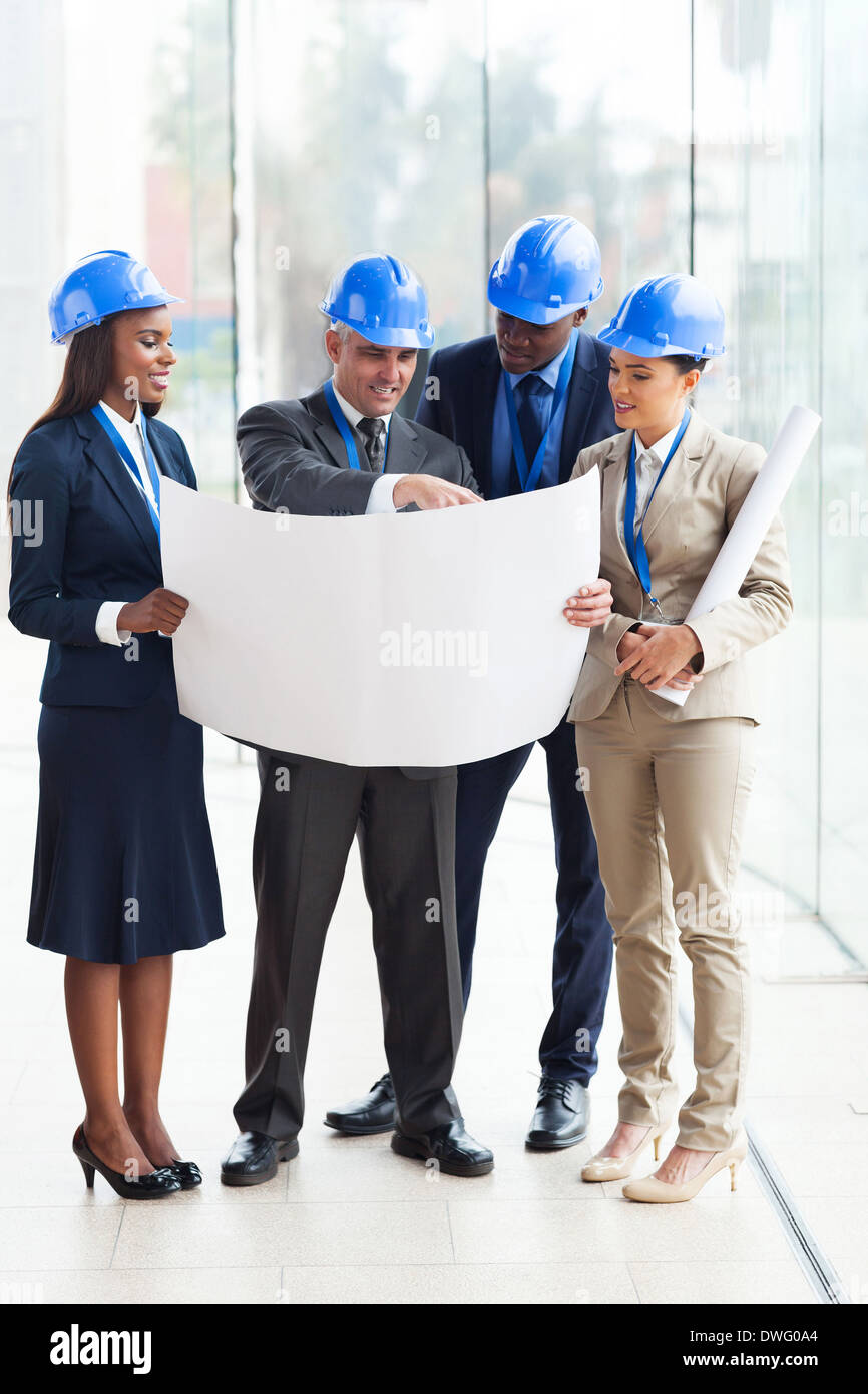 group of four architects working on a project at the office Stock Photo