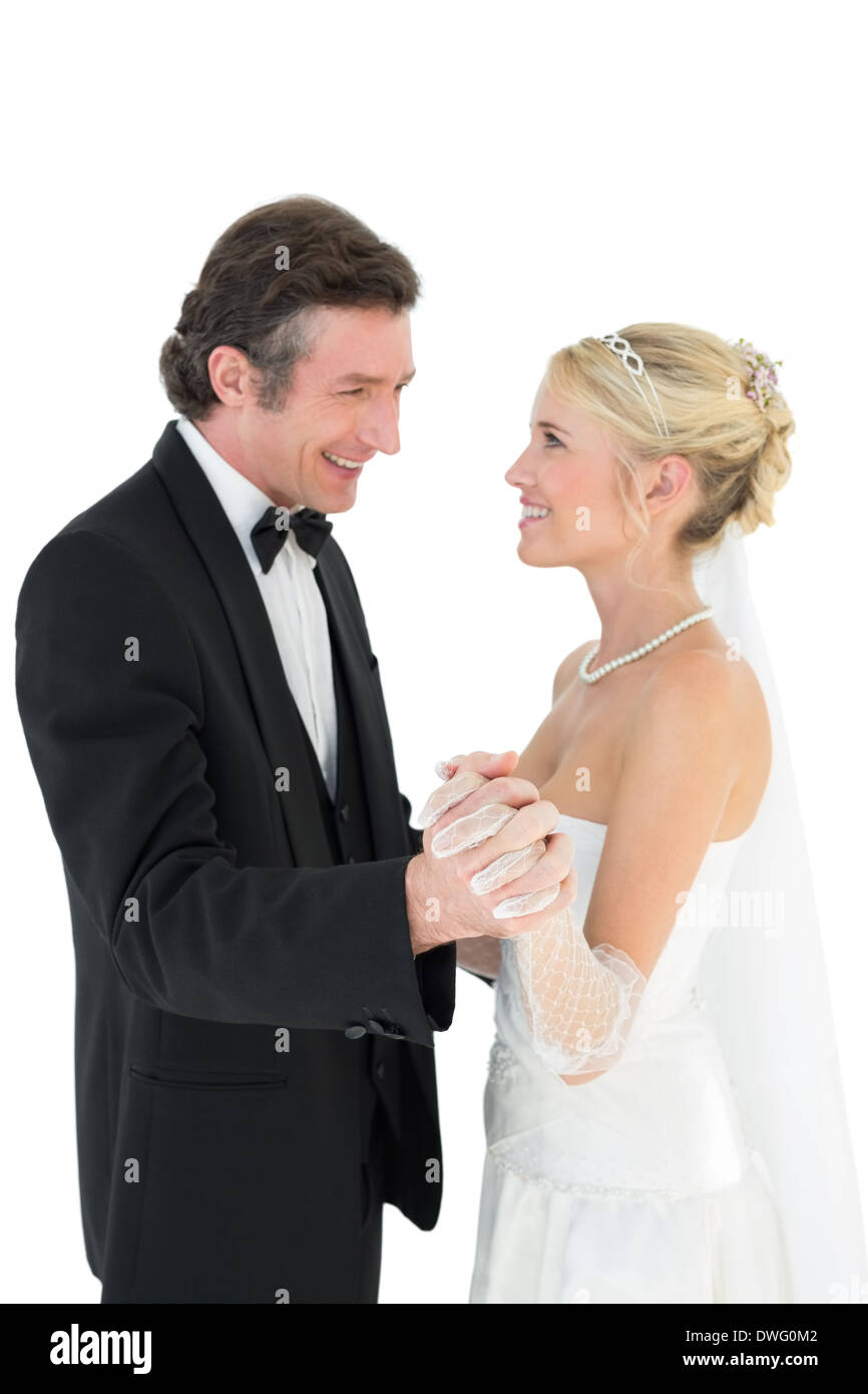Newly wed couple holding hands while dancing Stock Photo