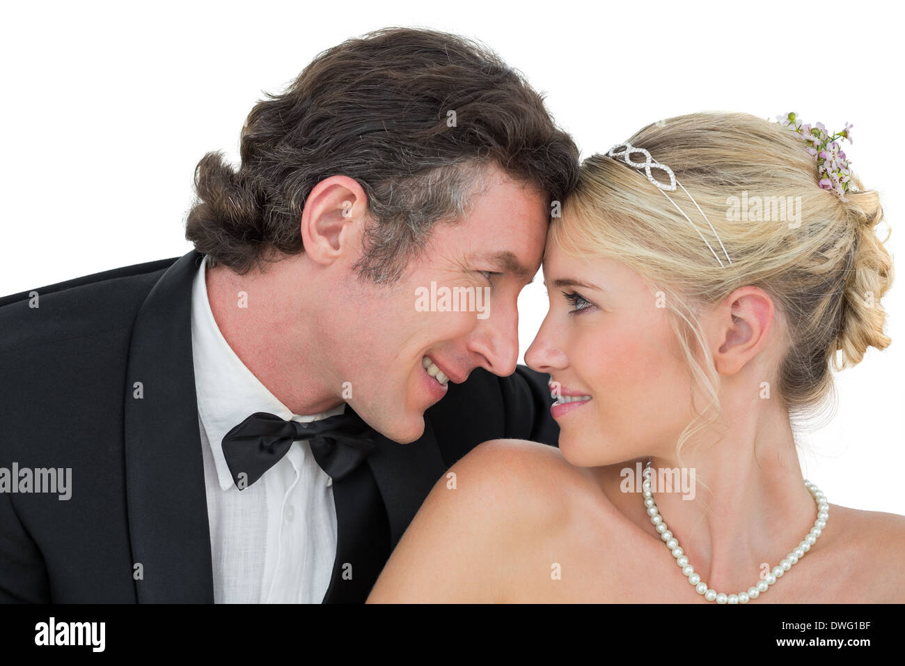 Smiling bride and groom with head to head Stock Photo