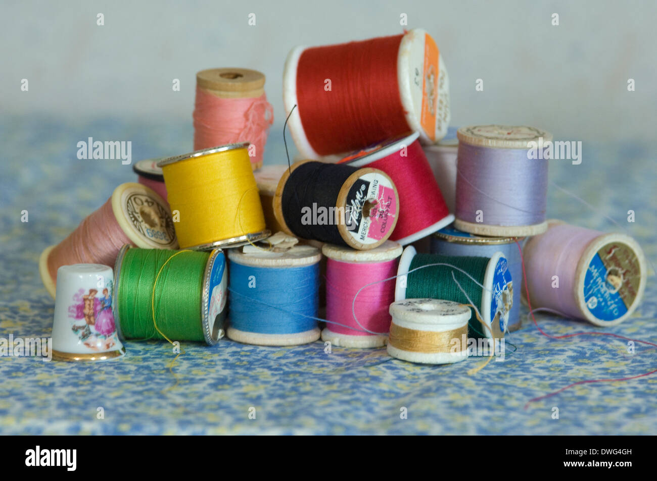 Spools of thread and a ceramic thimble. Digital photograph Stock Photo