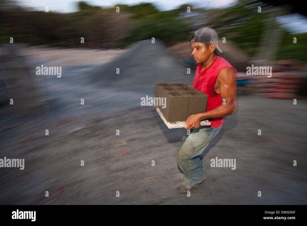 Penonome, Cocle province, Republic of Panama. 7th March, 2014. Raul Antonio Alueo, 29, carries newly pressed concrete blocks at the construction material plant Industrias Gordon S.A in Penonome, Cocle province, Republic of Panama, on Friday March 7, 2014. Stock Photo