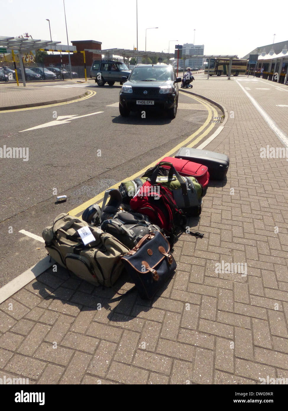 A pile of luggage on the side of the road at a cruise terminal Stock Photo