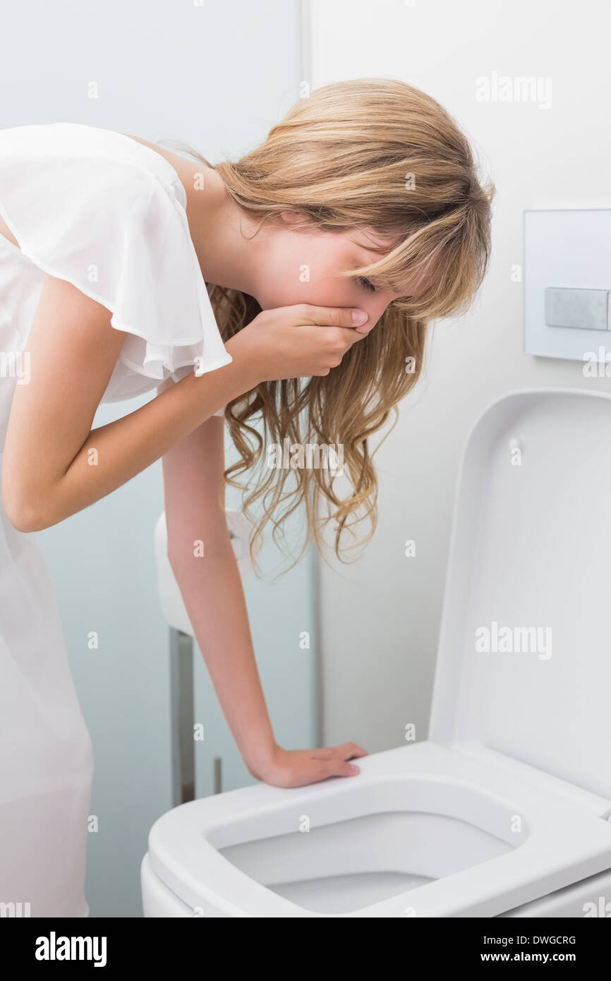 Sick Young Woman Leaning On Open Toilet Seat. Stock Image 