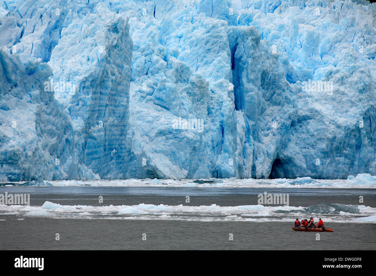 Tourists in a zodiac view the terminus of the San Rafael Glacier in Patagonia in southern Chile in South America. Stock Photo