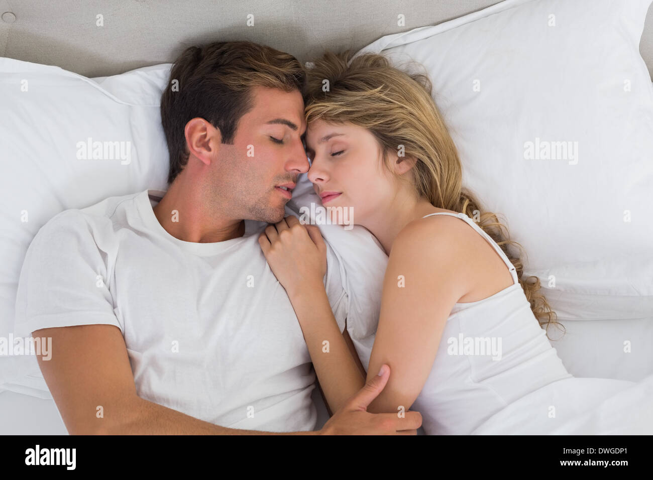 Couple sleeping together in bed Stock Photo