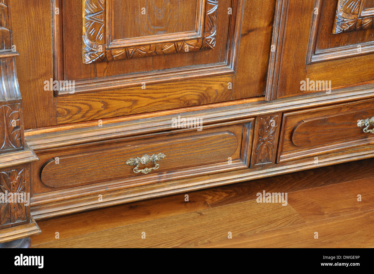 Old Antique Wardrobe With Drawers On The Wooden Floor Stock Photo