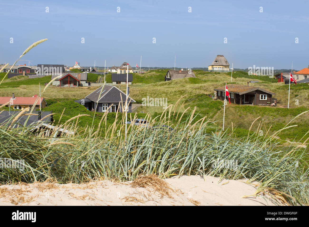 Panoramic view of summer houses at the North Sea shores of Western Jutland, Denmark. Sun is shining and the sky is bright blue. Stock Photo