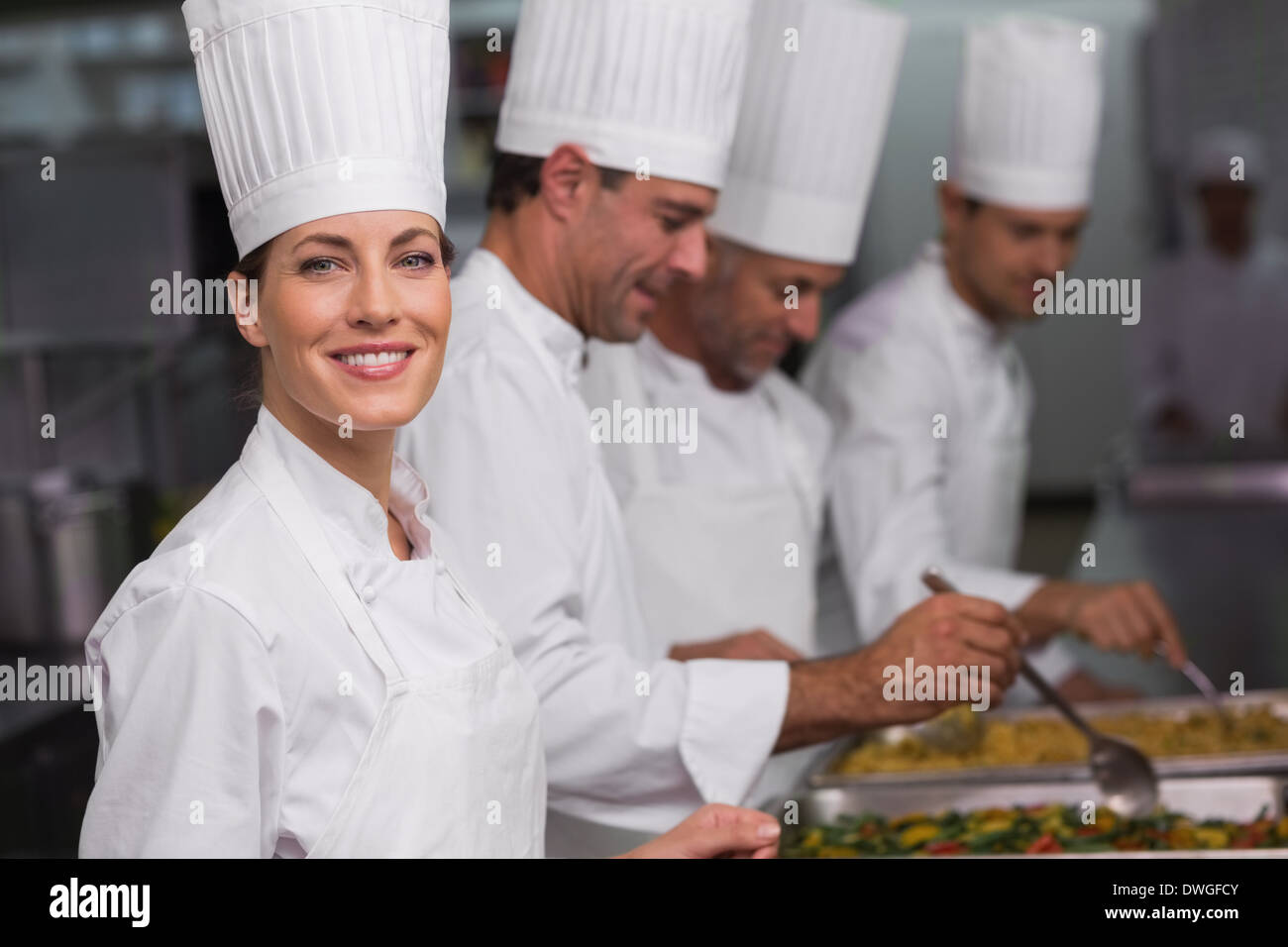 Chefs serving hot food from serving trays Stock Photo Alamy