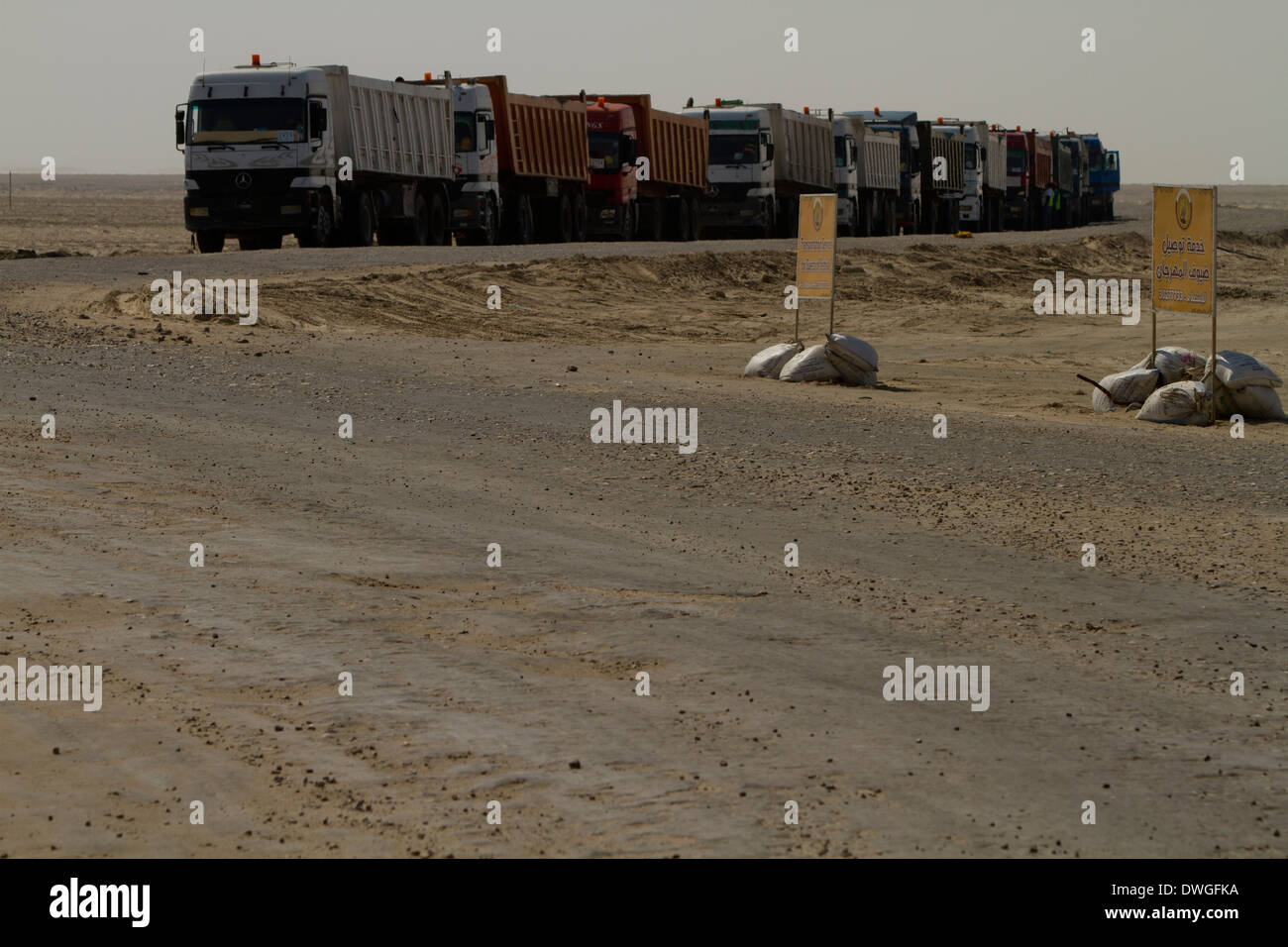 Qatar Construction building site Line of trucks Desert Stock Photo