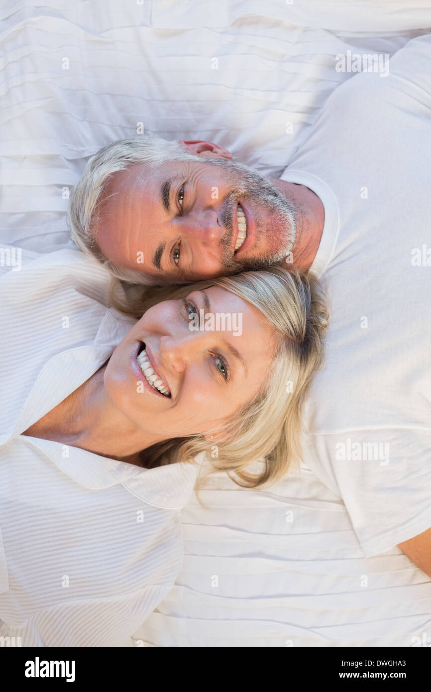 High angle portrait of happy mature couple lying in bed Stock Photo - Alamy