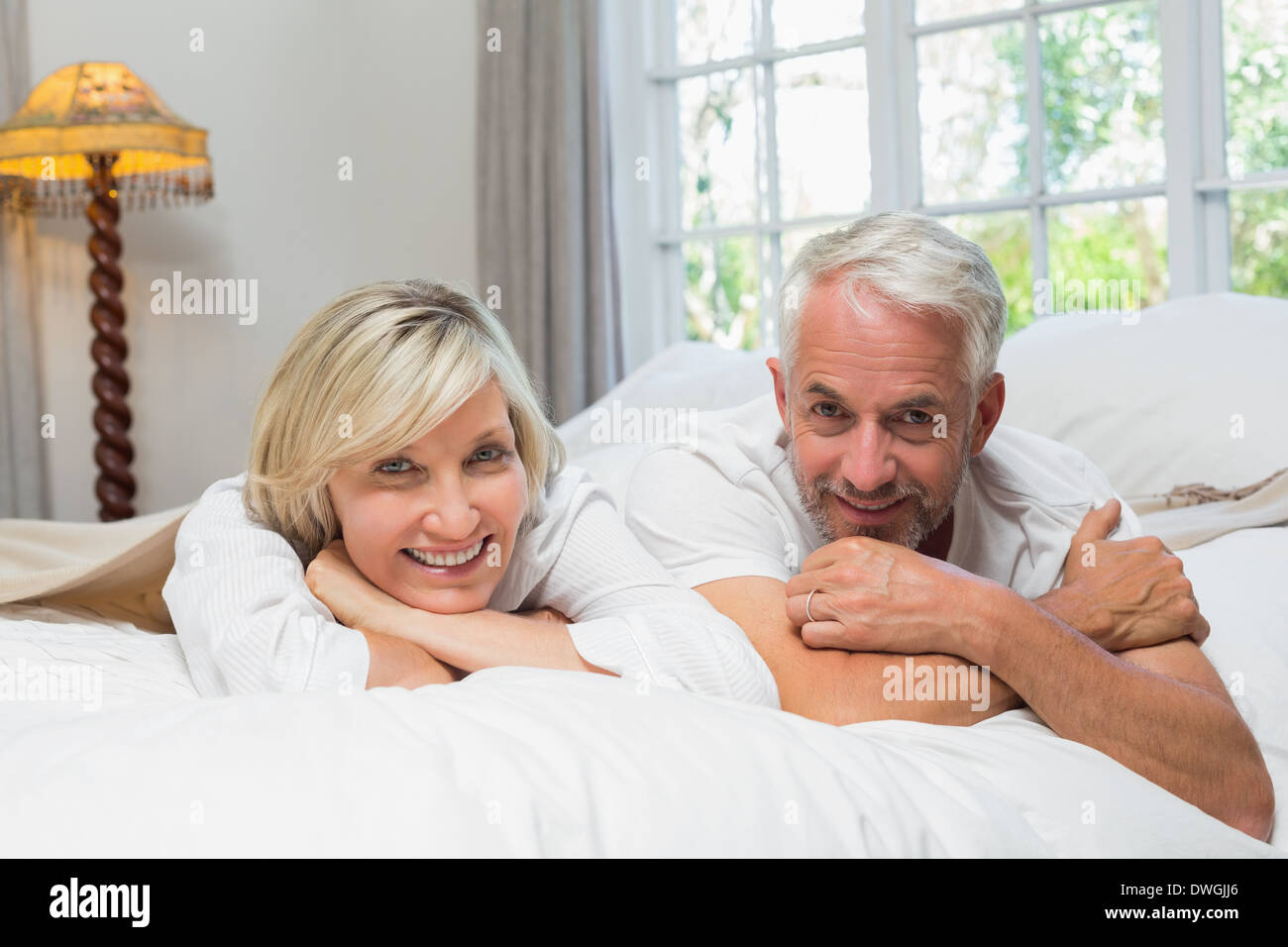 Portrait of a happy mature couple in bed Stock Photo