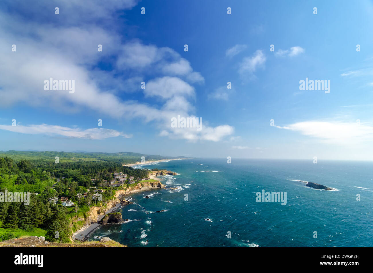 Lush green Oregon coast with blue sky and Pacific Ocean Stock Photo