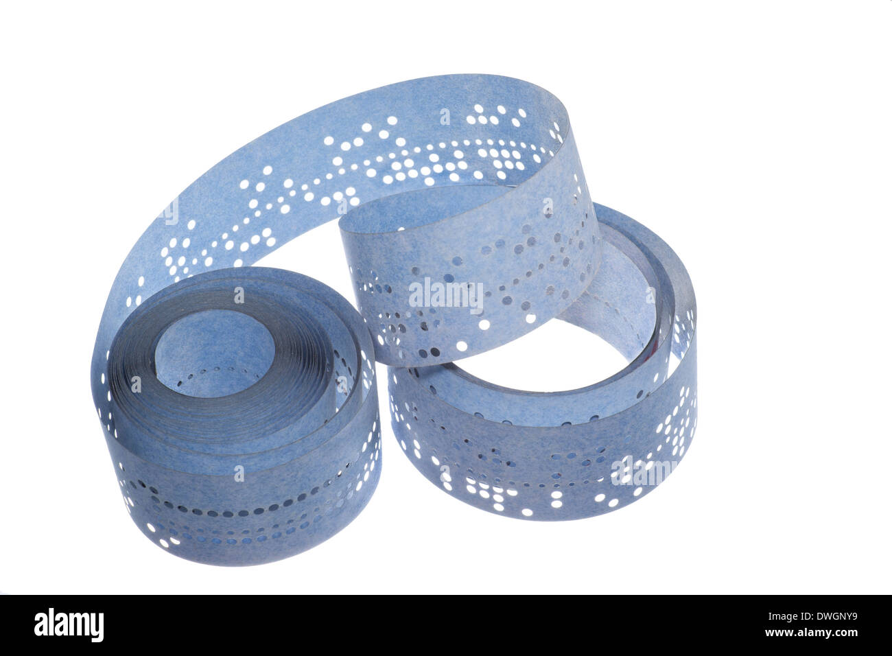 vintage punched tape, closeup and isolated on white background Stock