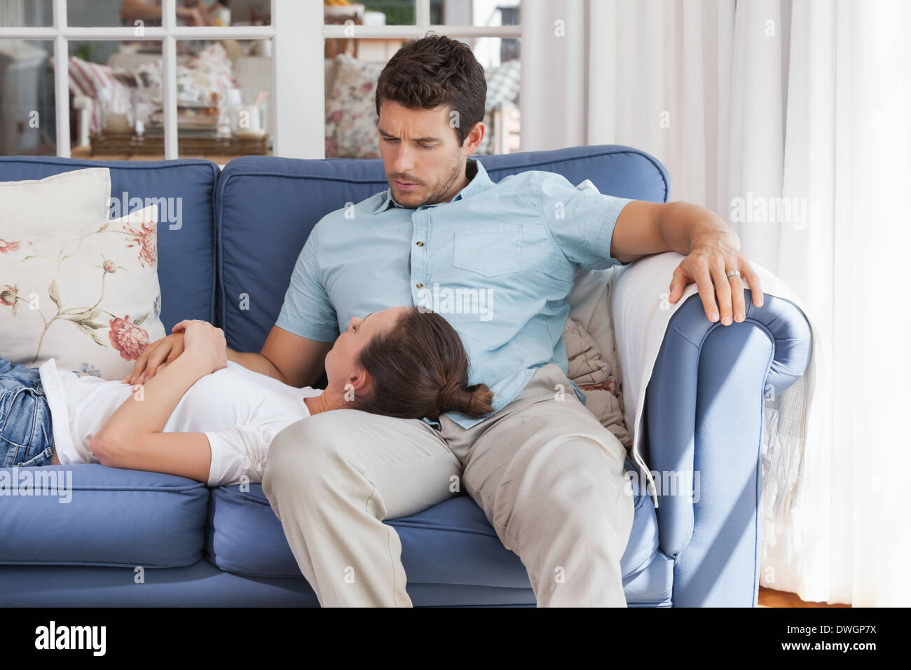 https://c8.alamy.com/comp/DWGP7X/young-woman-resting-on-mans-lap-on-couch-DWGP7X.jpg