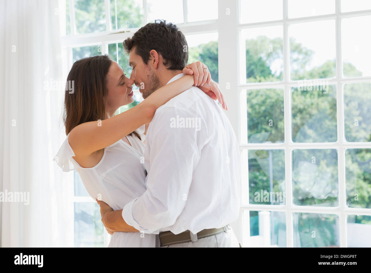 Couple kiss home indoors standing hi-res stock photography and images -  Page 2 - Alamy