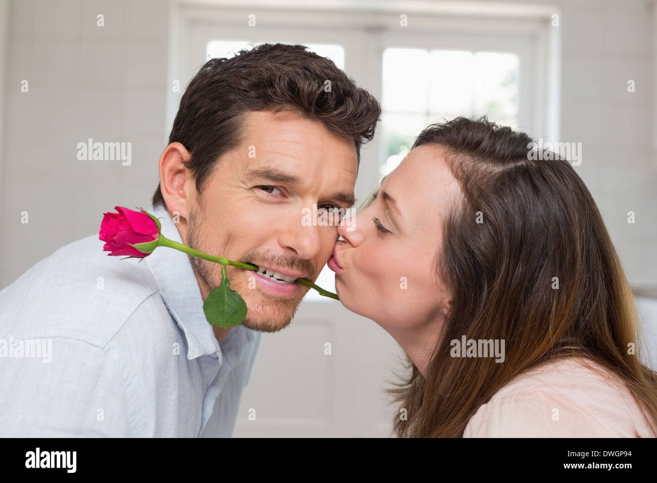 Side view of a loving woman kissing man Stock Photo - Alamy