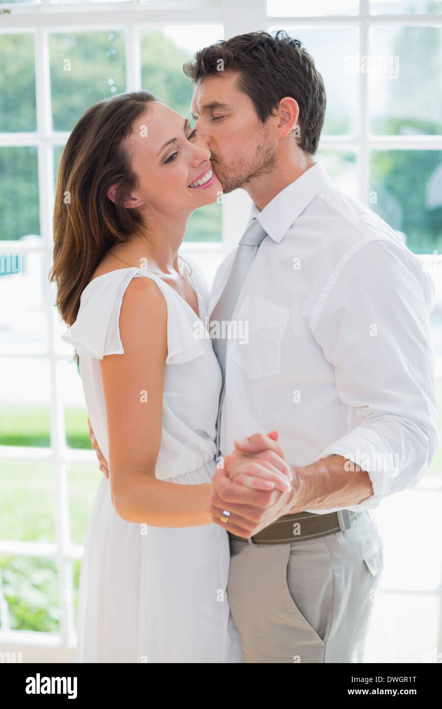 Loving young couple holding hands at home Stock Photo - Alamy