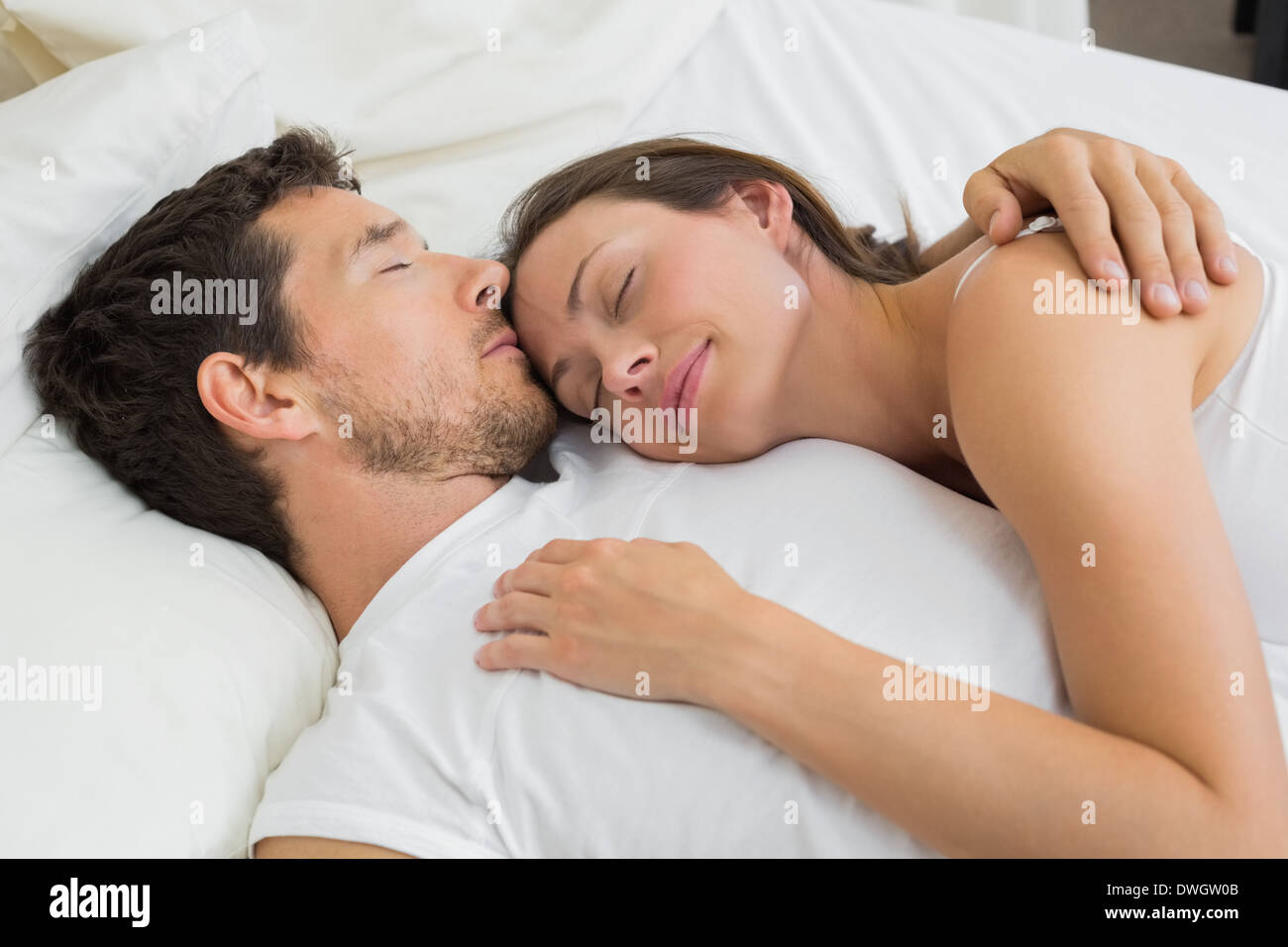 Happy couple in love sleeping together at home Stock Photo - Alamy