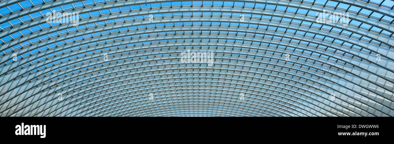 Panoramic abstract architecture background pattern image of curved geometric repetitive glass roof panel shapes in public building in Belgium Europe Stock Photo