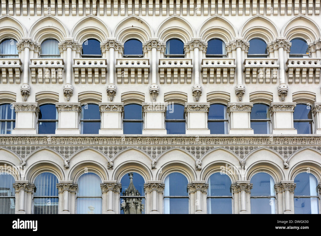 Series of repeated window arches on office building façade in The City of London England UK Stock Photo